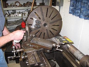 TumblingShaftFixtureFabrication21Jan09 011 Bill keeps one hand on the carriage crank and the other on the tool holder keeping a tool bit shim from rattling out during the interrupted cut.