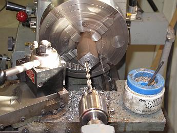 TumblingShaftFixtureFabrication24Jan09 003 Drilling the pilot hole, then we will enlarge the holes and ream to a finish through the block.  Deep drilling a hole like this will make you wish for a lever action tailstock.