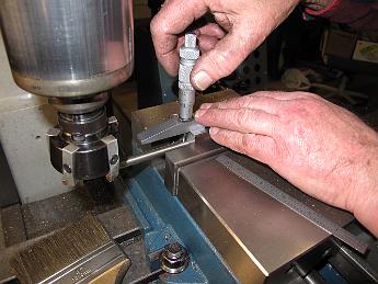 TumblingShaftFixtureFabrication24Jan09 005 Using a depth mike to measure the depth of the block relative to the hole.  We do this on both sides to make sure the machined surface is parallel to the reamed hole.