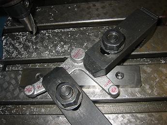 TumblingShaftLever12Nov08 002 Machining the lever for the engineers side. The problem with this clamping setup is that any twist or differences in height between the two legs results in us cutting the ends to the wrong height, the part unbends (moves) when the clamps are removed.