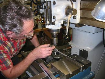 ValveMotion26Nov08 005 Using a magnifying glass to align the clamping fixture under the scribed centerline on the part.