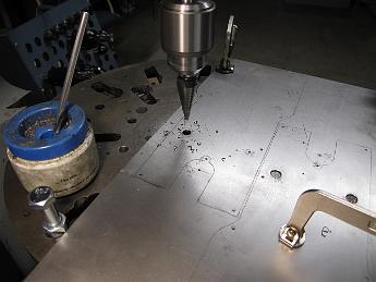 CylinderJacketing3June09 002 3-June-09  Using a step drill bit to cut the holes in the cylinder jacketing.  Each hole was piloted before using the drill, the advantage of this style is it does not 'grab' the sheet metal when breaking through to the other side.