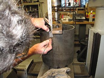 DrillingSmokeboxShell21Feb09 001 21-Feb-09 It's lousy weather outside today, nothing can be done at the track so into the shop we go.  Using the same DRO bolt circle program, we have made marks on the rim of the shell for the steam pipe, handrails, and smokestack holes to go on the side of the shell.  Using the rim marks and the combination square, the hole locations are marked on the side.