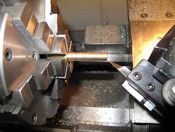 IMG_2453 Turning a piece of brass with a specially ground tool to make the new valve stem. The special tool is needed to put an inside cup face on a shoulder, which holds the rubber washer in place.