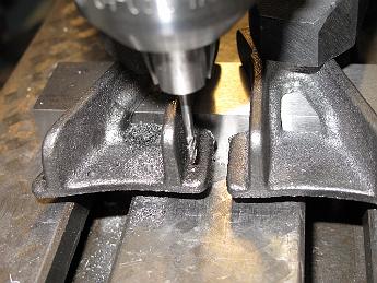 SmokeboxHinges28Mar08 005 The supplier now provides these brackets in aluminum only, due to the casehardened skin these thin sections have. We chewed up a HSS and a TiCN coated drill bit before finding a small Carbide ball mill we could use.  Even though this little mill had one damaged flute, and really wasn't a center cutting mill, it chewed through the tough cast iron without complaint.  Sometimes it is all about getting the right tool for the job, and in this case, it is carbide for cast iron.