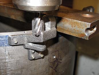 SmokeboxShellHinges1Apr08 001 1-Apr-09 With the shell hinges temporarily bolted on and the smokebox shell held down on the table vertically, we use a carbide ball end mill to cut the bearing surfaces on the hinges.